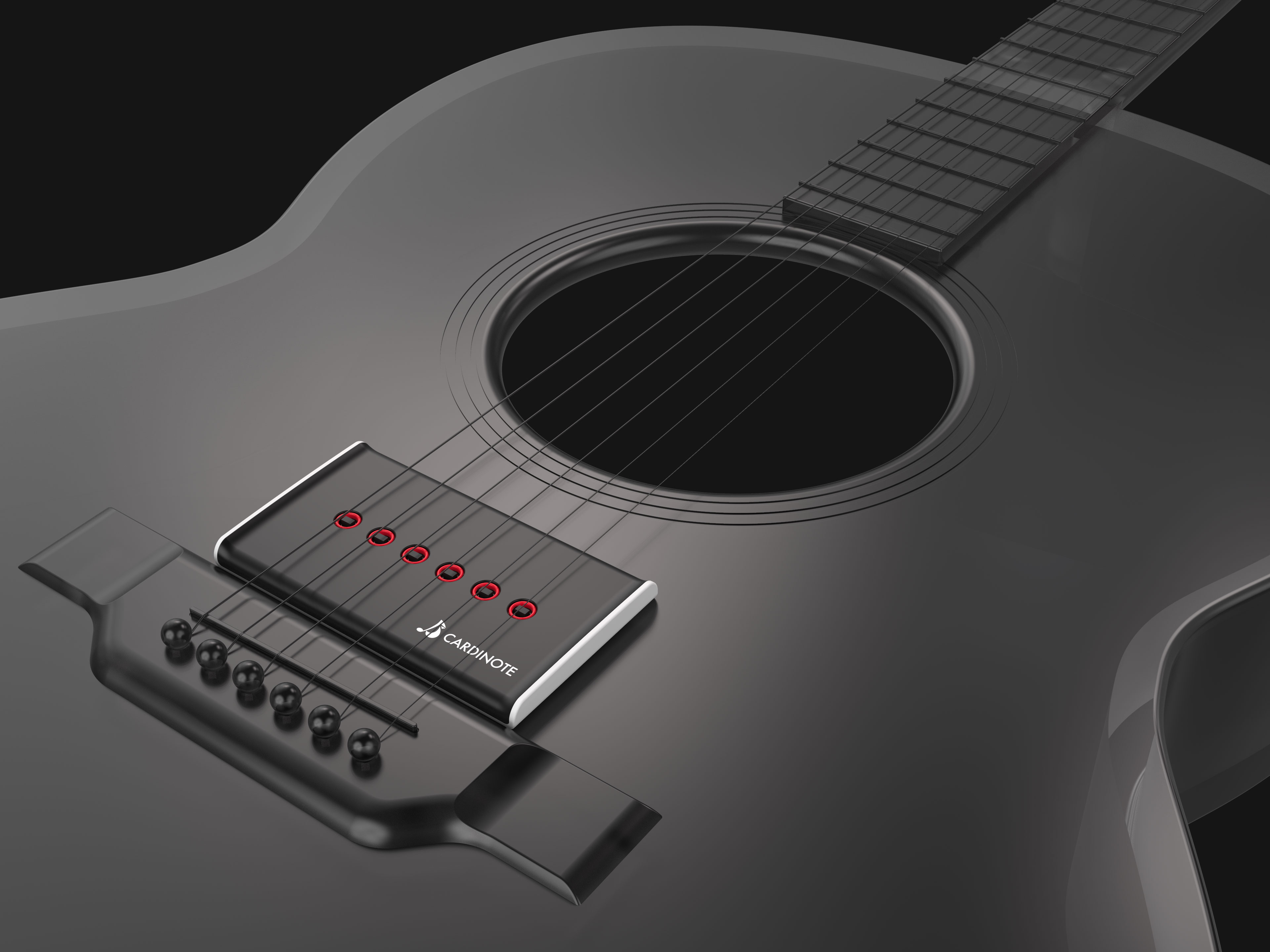 Cardinote Brio on black guitar and dark background with focus on bridge area.