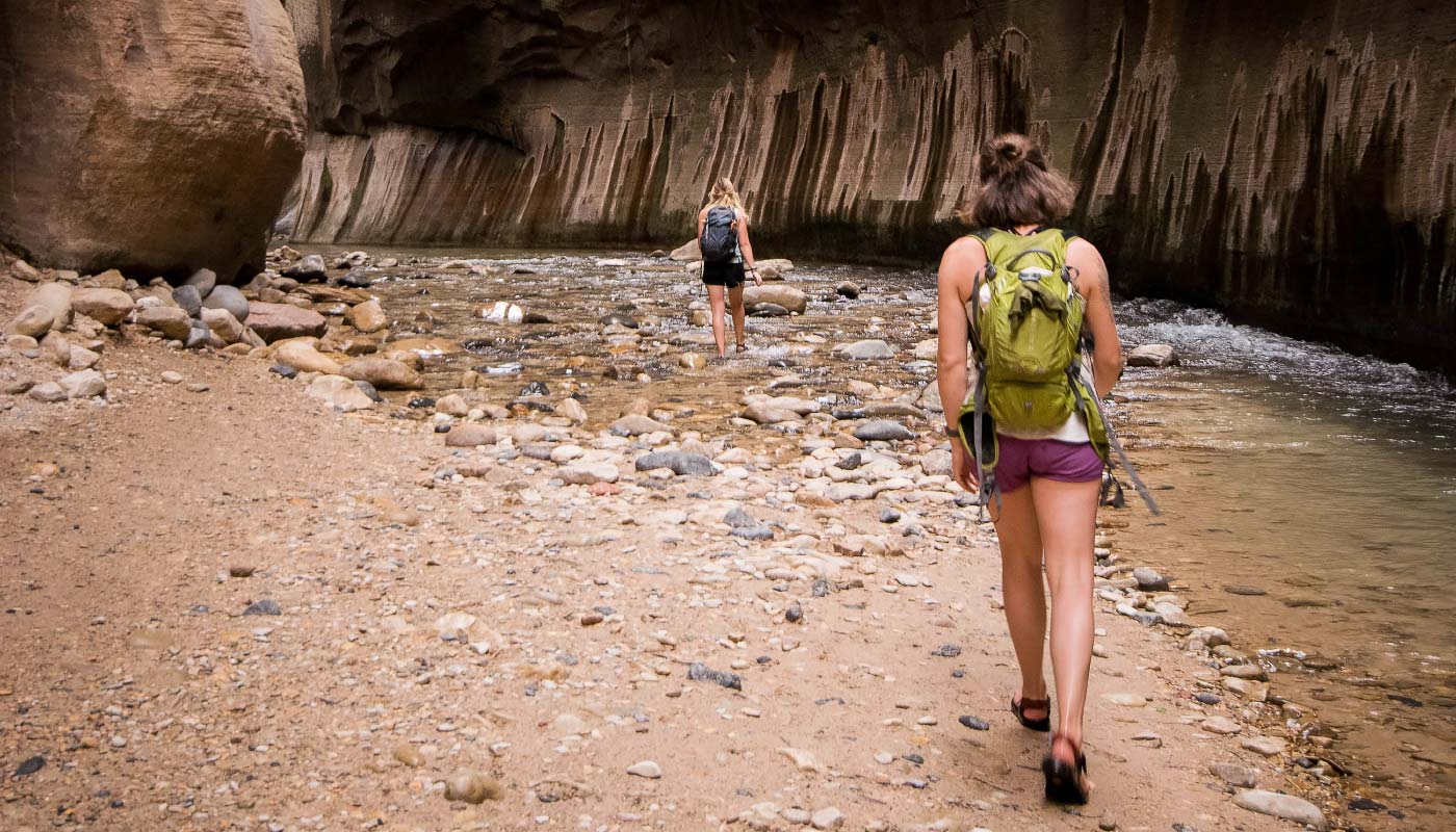 woman hiking through Zion Canyon