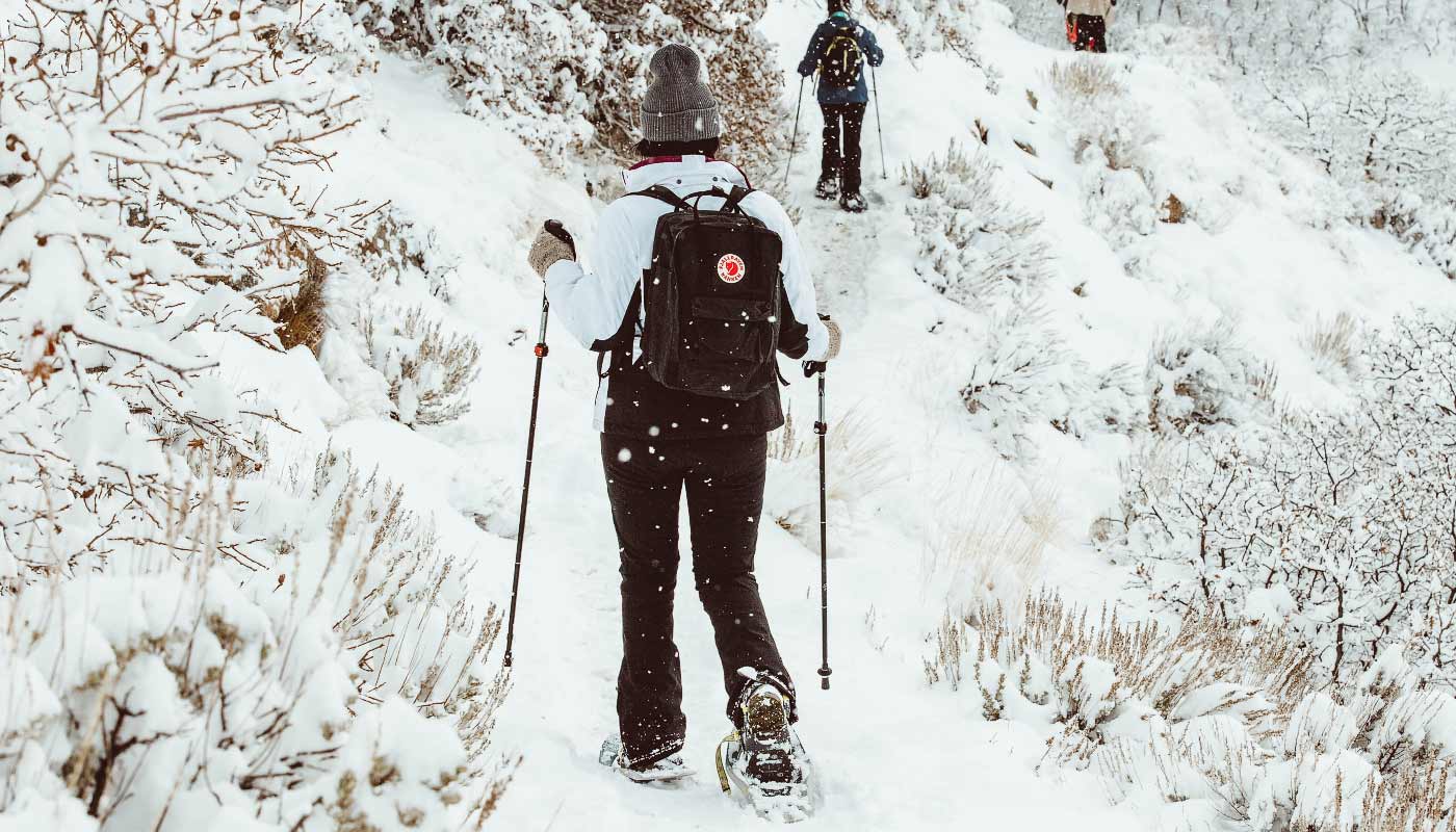 Woman snowshoeing up a mountain in Colorado