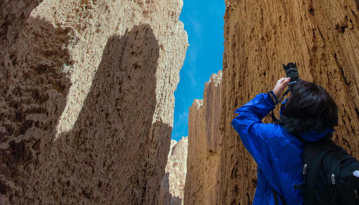 Photographer taking pictures of the Cathedral Gorge spires in Nevada