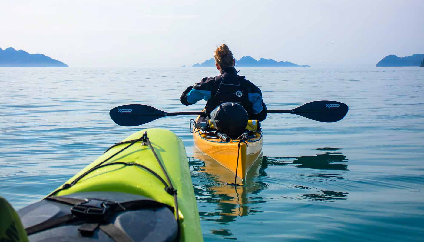 Sea kayakers kayaking around islands in Washington
