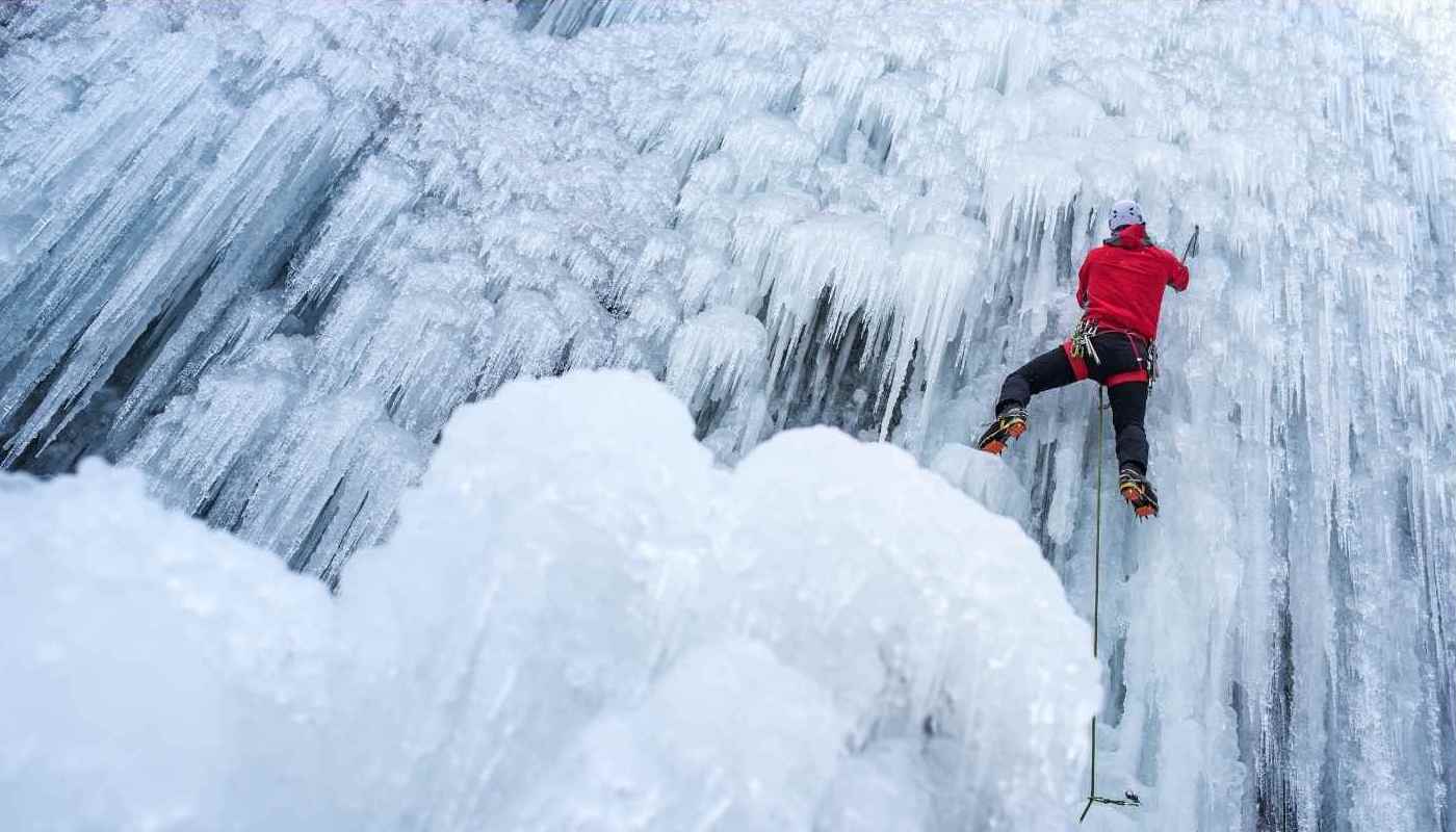 Ice climbing a frozen waterfall.