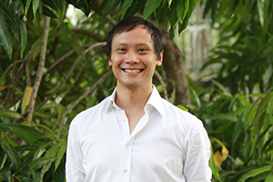 Our founder Vernon in the jungle wearing a white shirt.