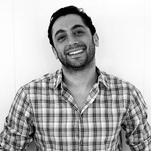 Our founder Diego wearing a plaid shirt and smiling
