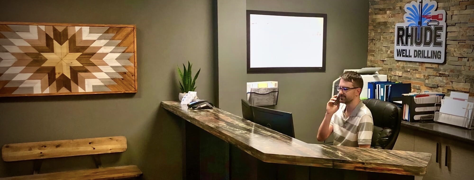 Rhude Well Drilling employee scheduling a well drilling consultation over the phone.