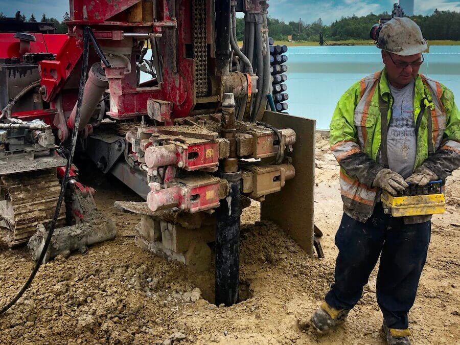 A well technician deepening a well for better water flow using well drilling machine.