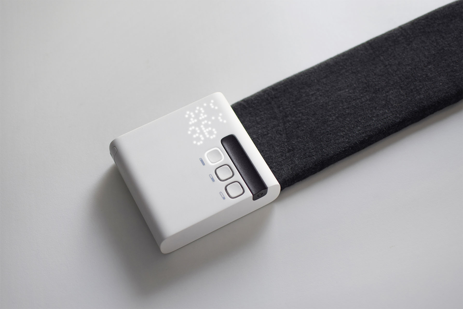 Hero shot of the Stratum heating and cooling desk mat, a minimal white box attached to a narrow fabric mat