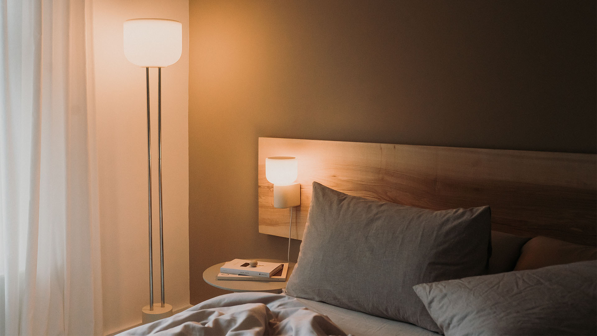 Arpeggio Floor and Wall Lights illuminating a minimal bedroom