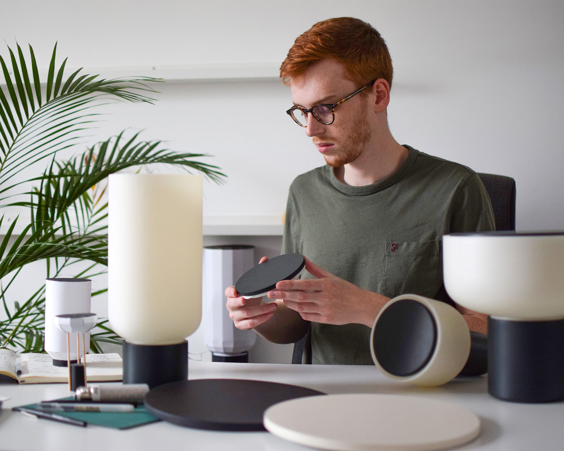 A photo of Tony Elkington inspecting parts of some Arpeggio lamp prototypes