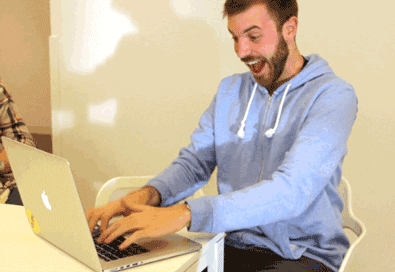 Excitedly Typing on Laptop
