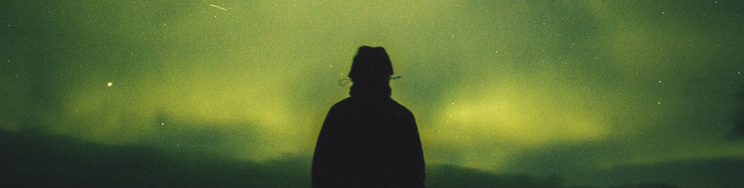 Man looking at Northern Lights