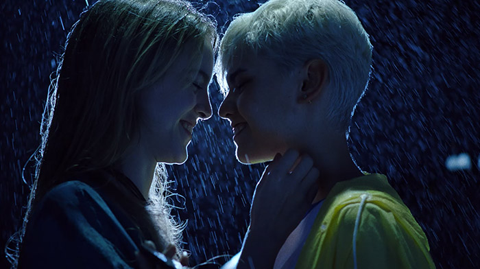 Samsung commercial still of queer couple about to kiss