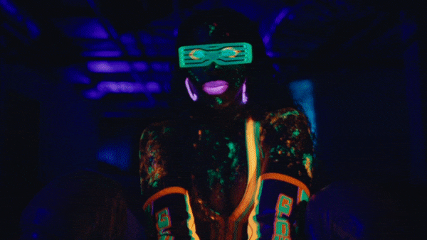 WWE commercial still of woman dancing with neon paint