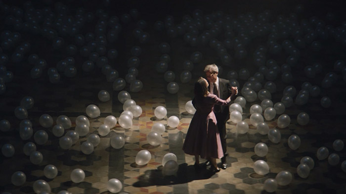 Movistar commercial still of older couple dancing in a ballroom full of white balloons
