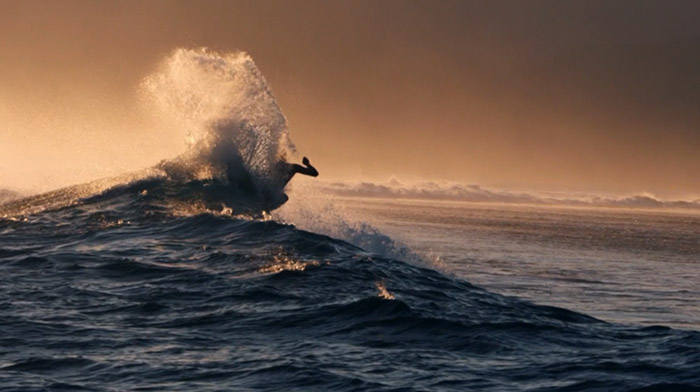 Quiksilver commercial still of surfer hitting the lip of a wave
