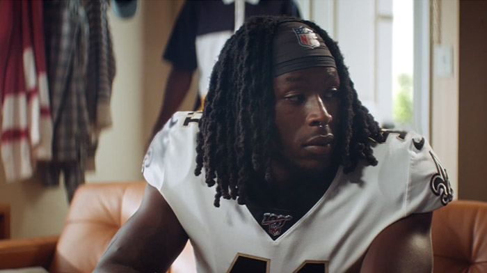 EA Madden commercial still of two young black football player looking over his shoulder