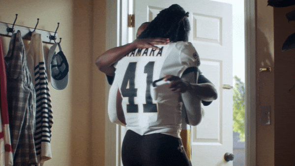 EA Madden commercial still of two young black football player looking over his shoulder