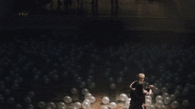 Movistar commercial still of older couple dancing in a ballroom full of white balloons