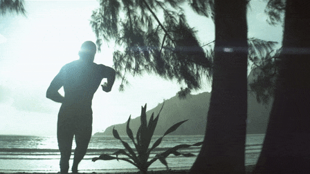 Ark commercial still of a muscular man running in the beach