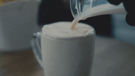 At Thirthy short film still of milk beaing poured into an overflowing glass