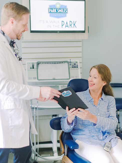Dr. Holz handing menu to patient