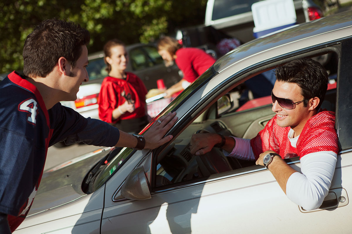 University college student in car talking to friends through window