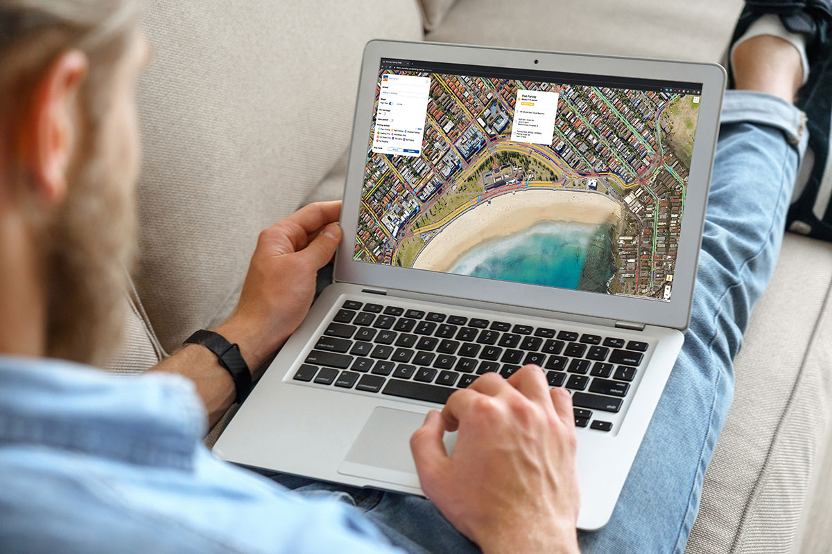 man using spot cities trip planner on laptop