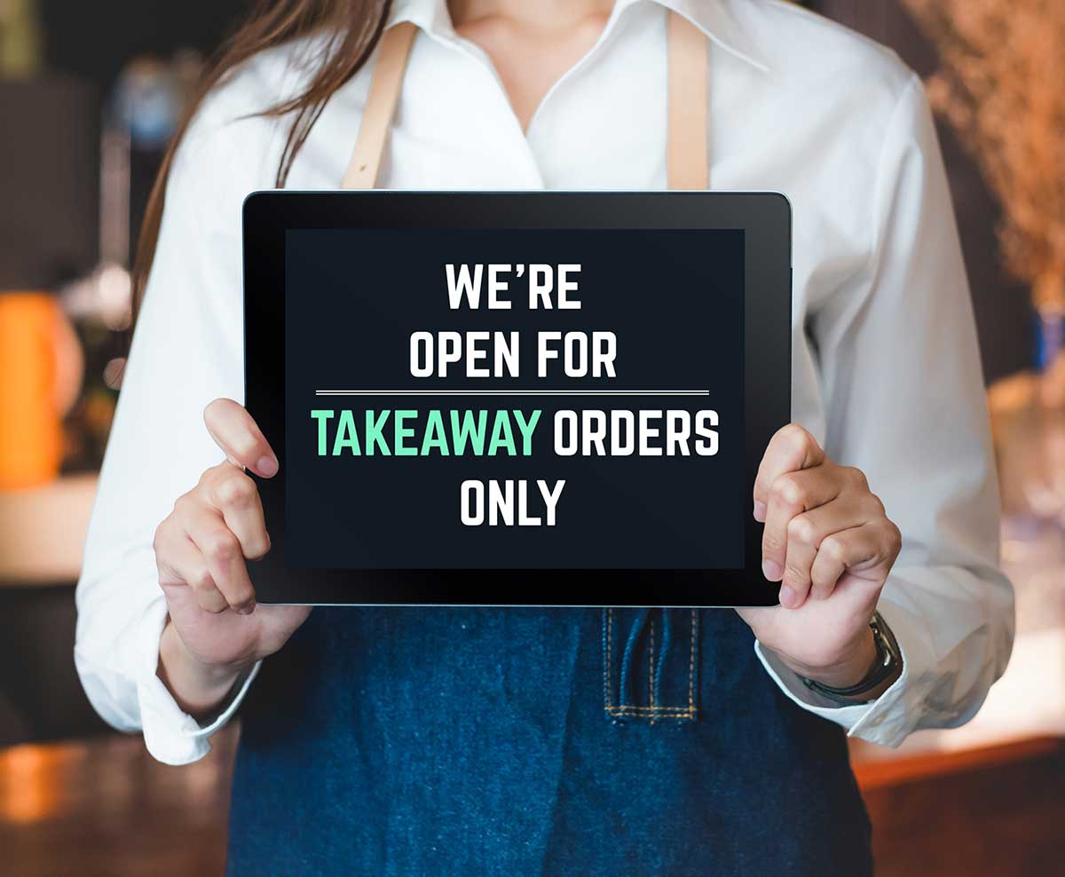Tablet signage reads "we're open for takeaway orders only"