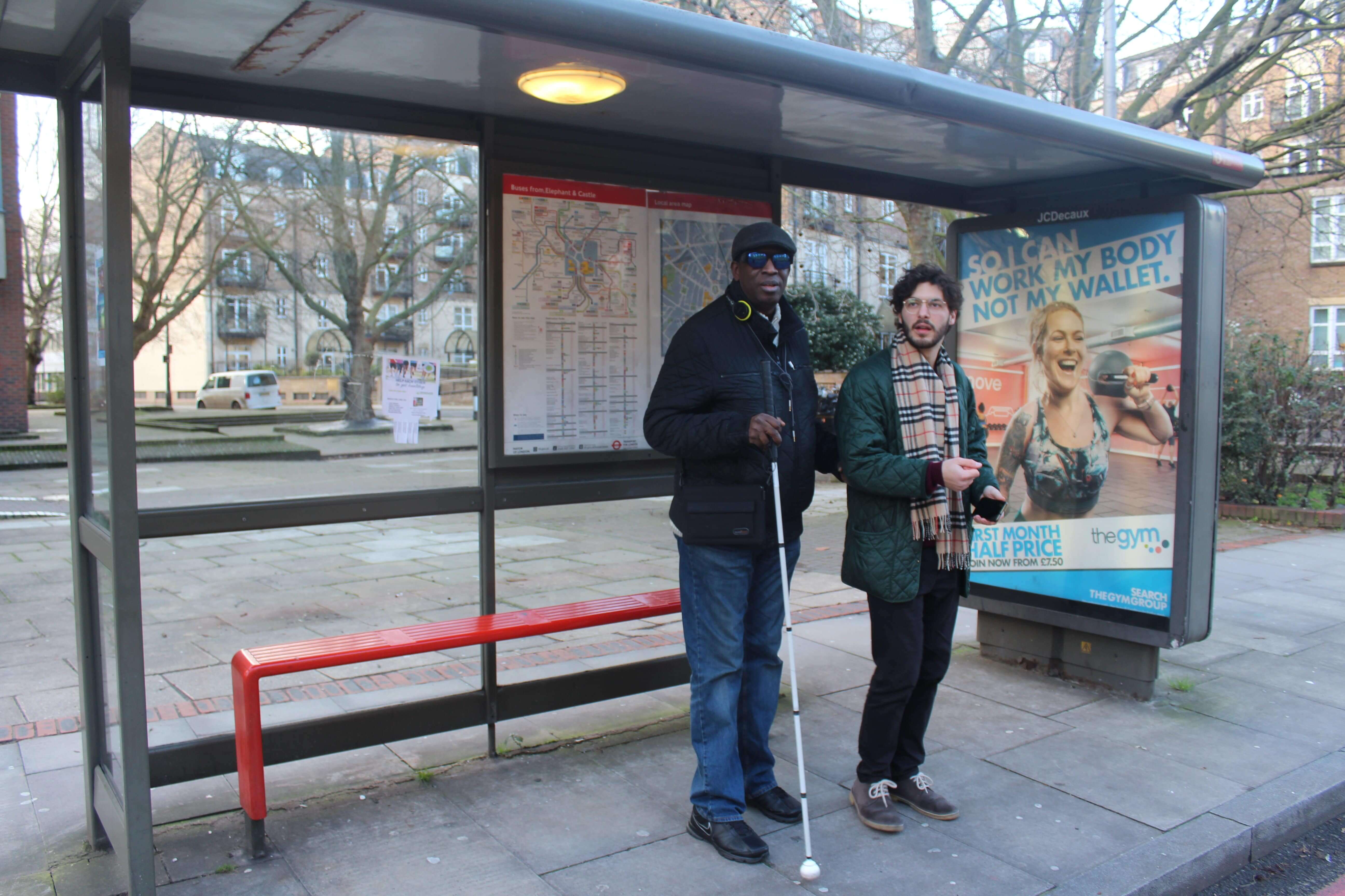 Bus stop - the last step of travel visually impaired person with volunteer