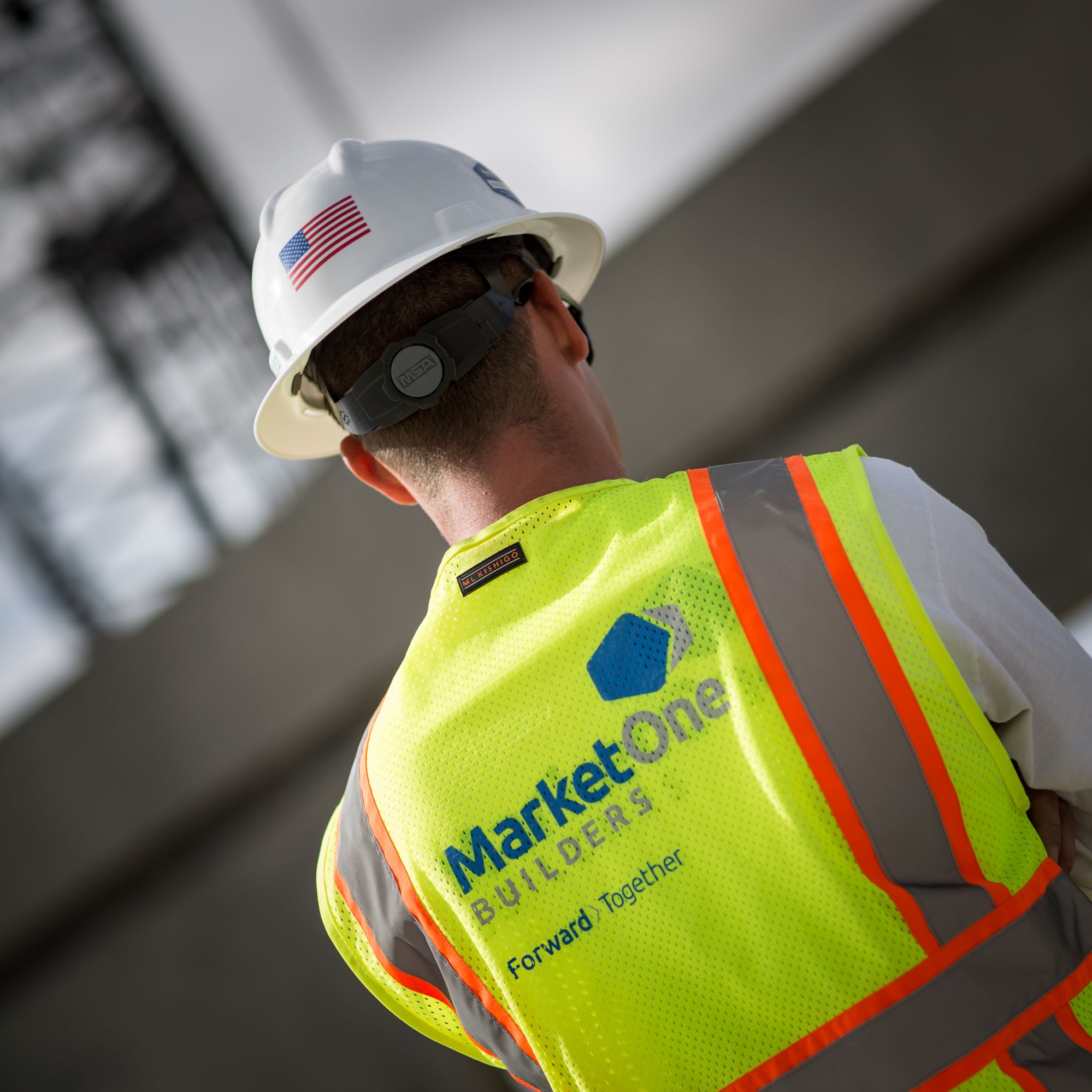 MarketOne construction worker with back to camera