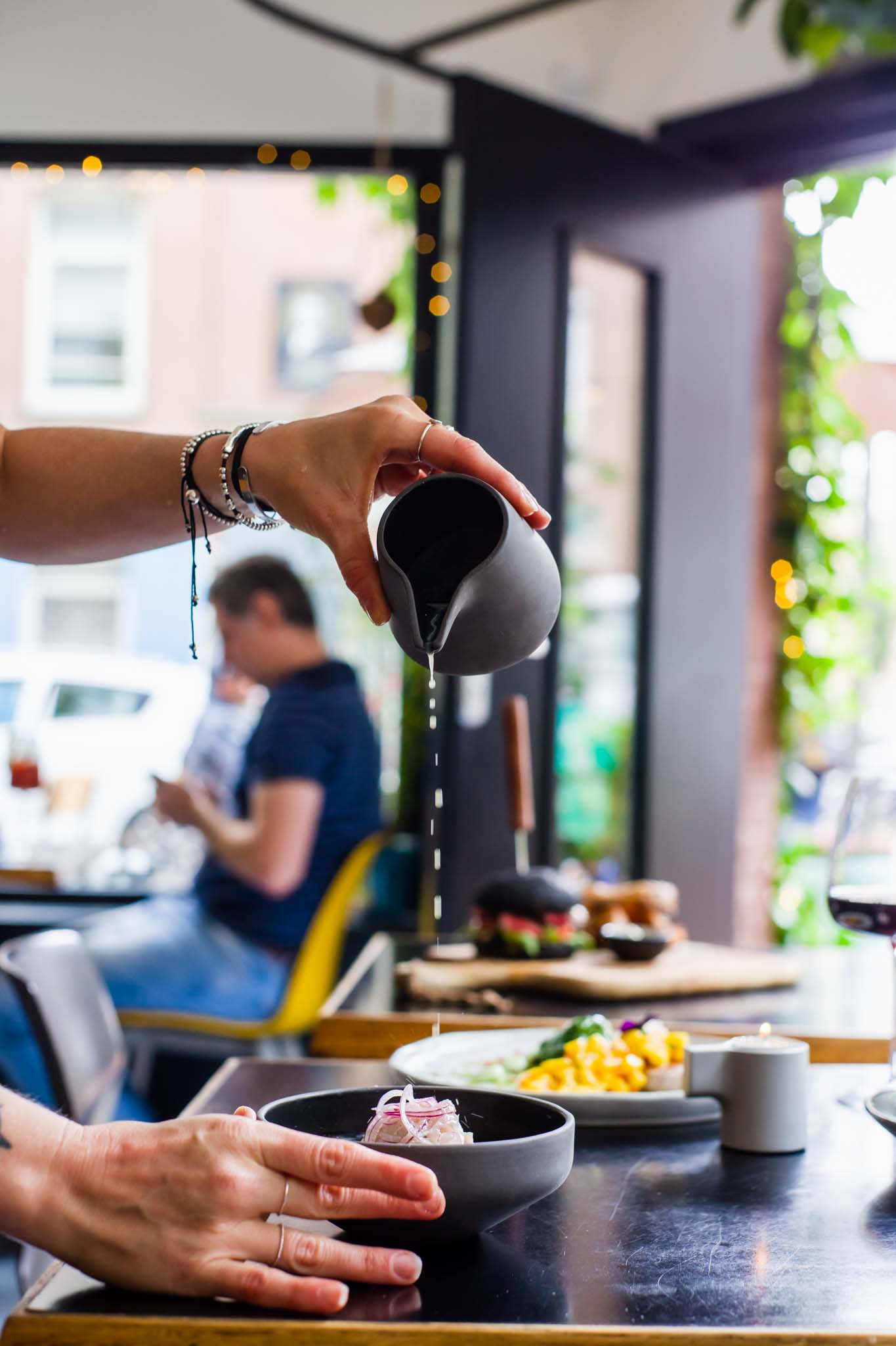 Chef pouring sauce on a dish in a restaurant