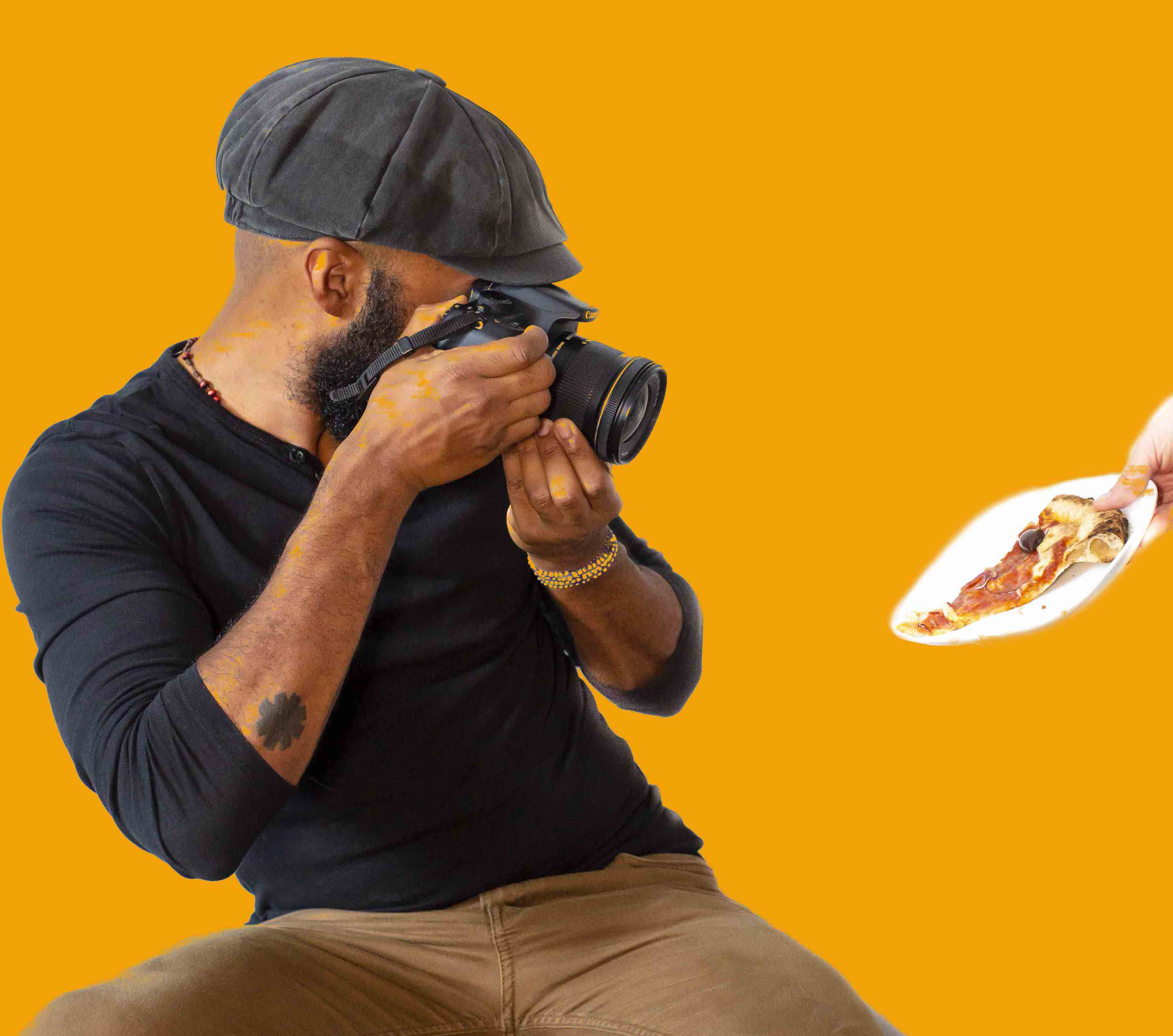 Photographer Louis Hansel taking photo of a slice of pizza