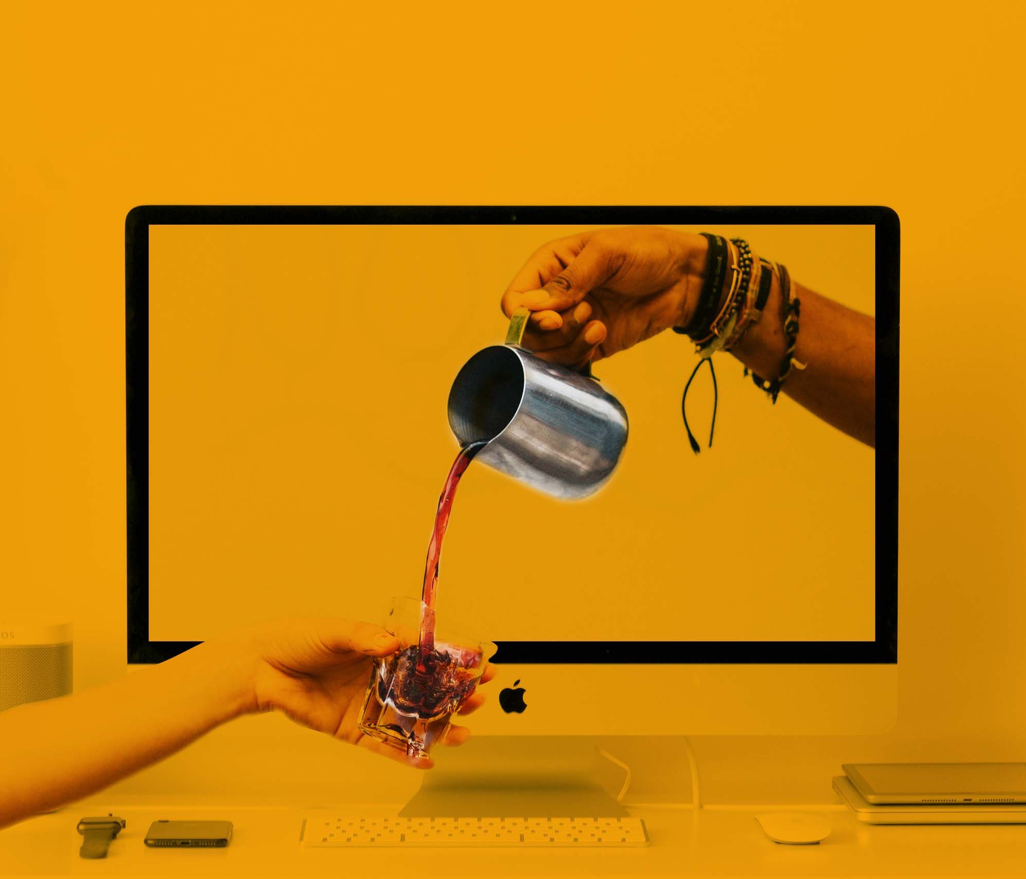 Hand pouring coffee from a desktop screen