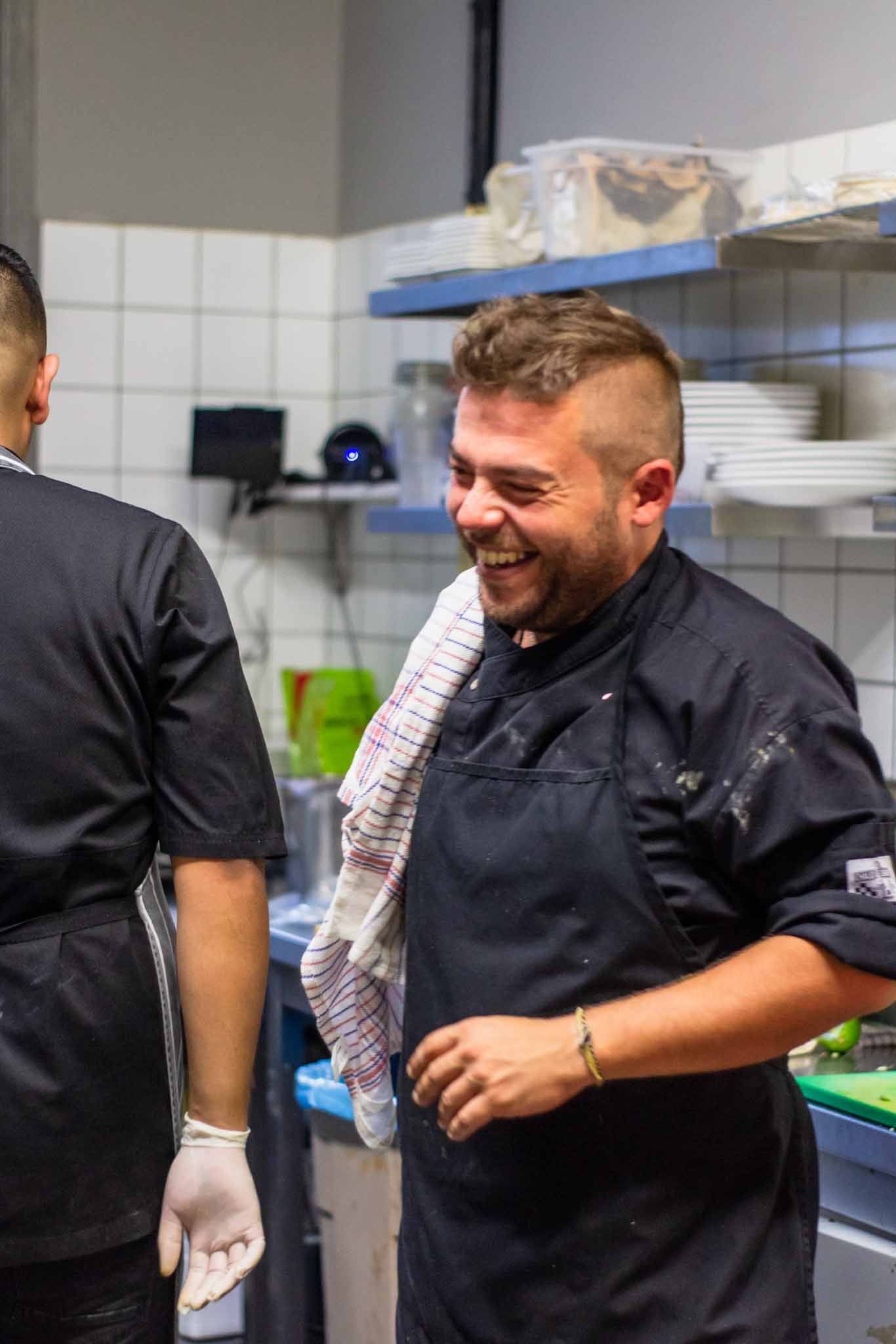 Two chefs in a Mexican restaurant sharing smiles