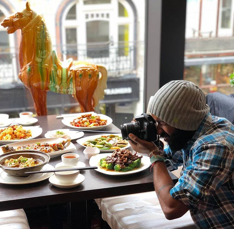 Photographer taking pictures of food in a restaurant