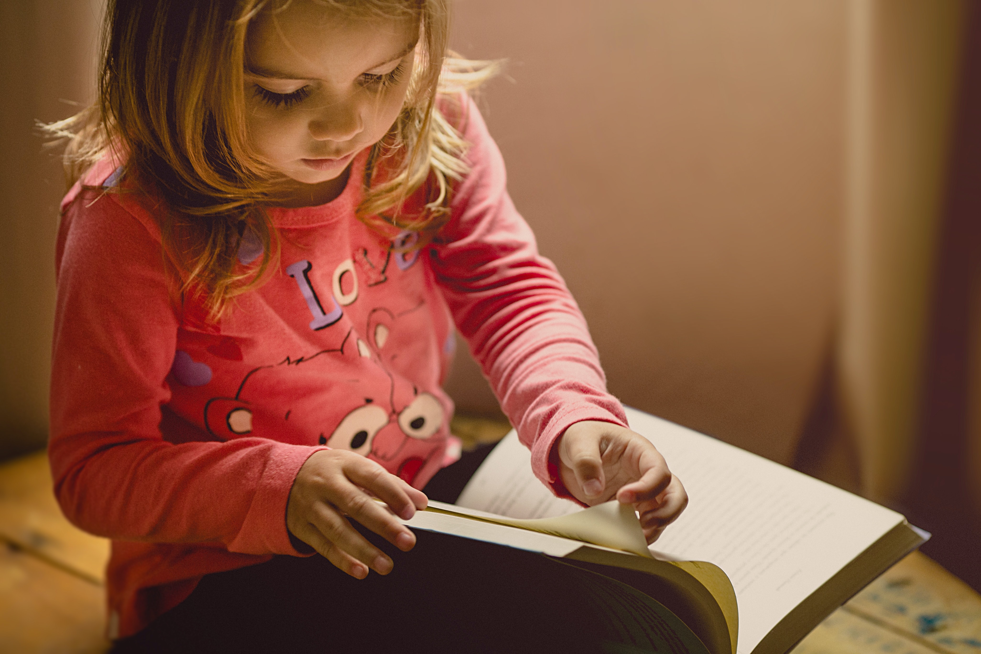 A young girl reading a book.