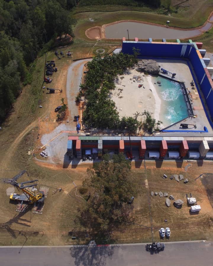 Aerial shot of one of the backlots featuring construction equipment and a beach.