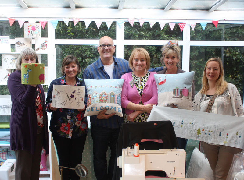 Group showing their cushions and lampshades made at the workshop
