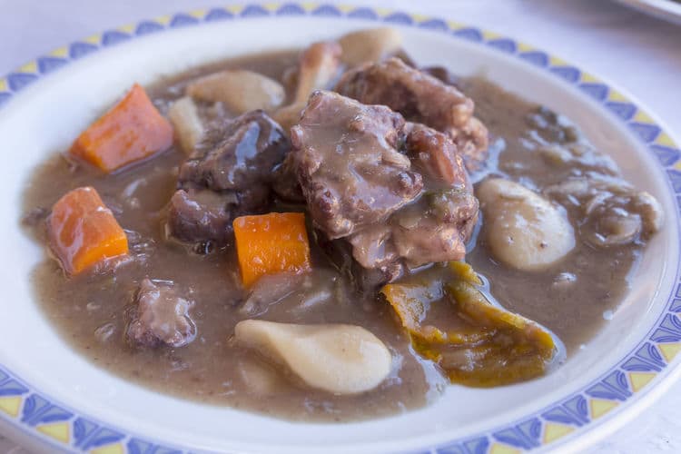 Bowl of nutritious beef stew with potatoes and carrot