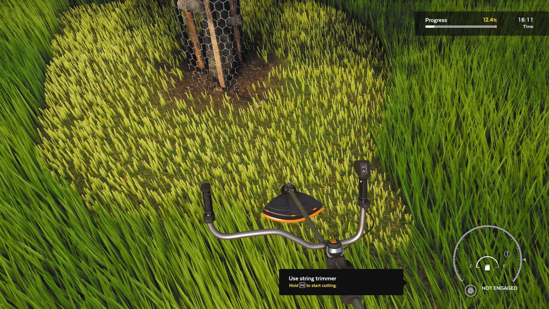 Using a grass trimmer to tidy up around a tree.