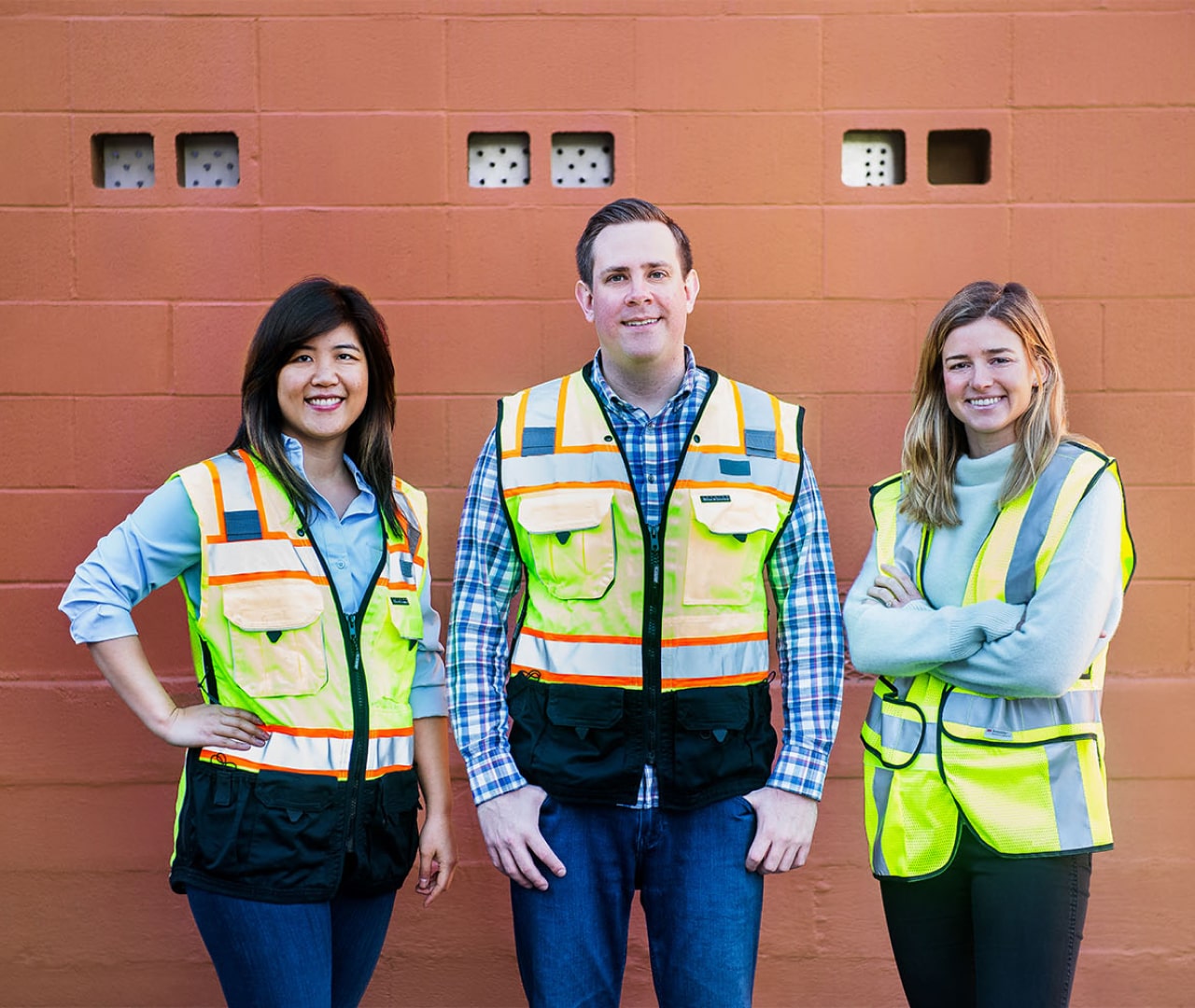 Gloria Lin, Joel Poloney, and Claire Wilson in construction vests