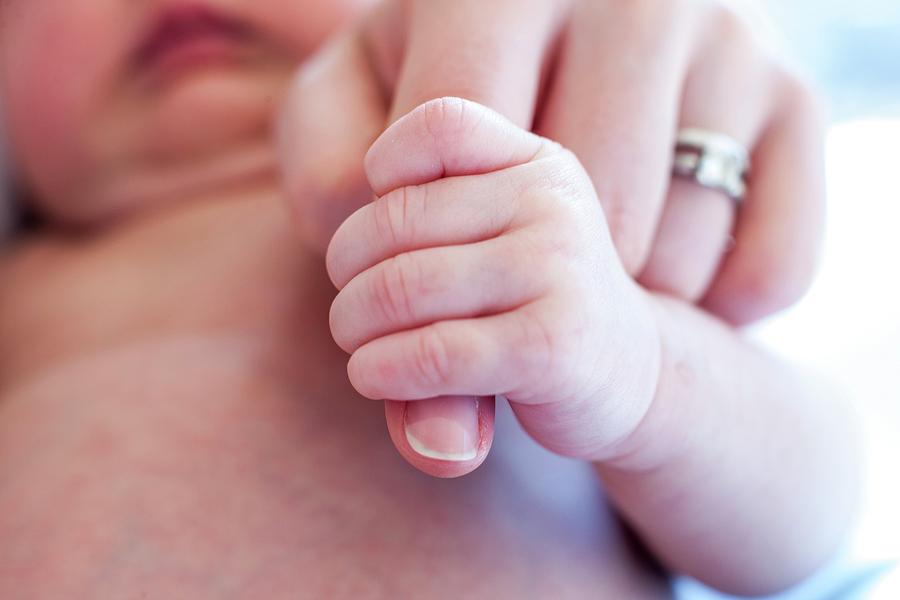 Baby Holding Mother's Finger Photograph by Ian Hooton/science Photo Library