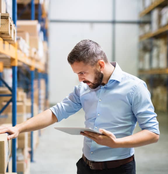 Man Checking Stock With Tablet