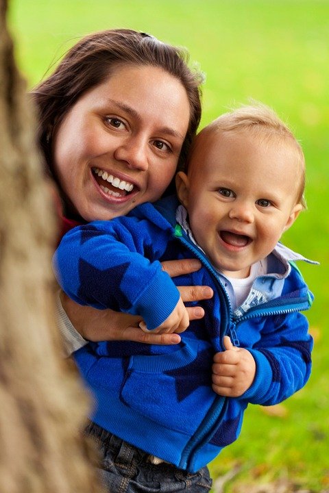 babysitter smiling with toddler heads close together