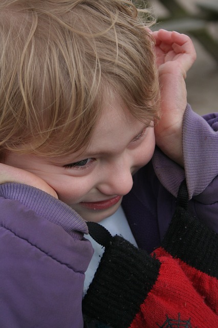 child holding their head in apparent distress