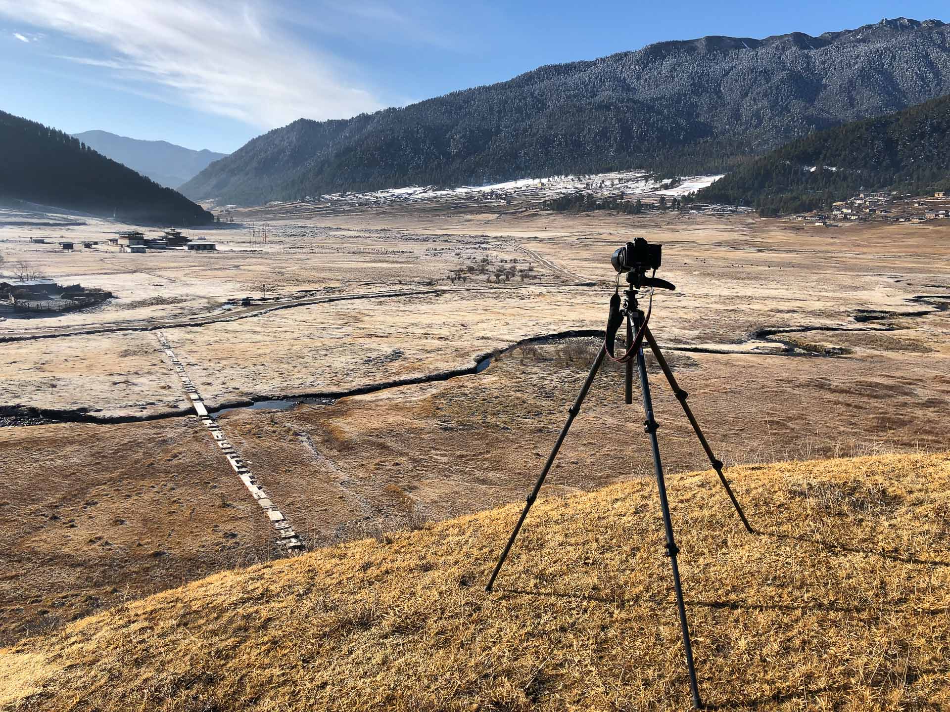Camera on a tripod overlooking a vast landscape