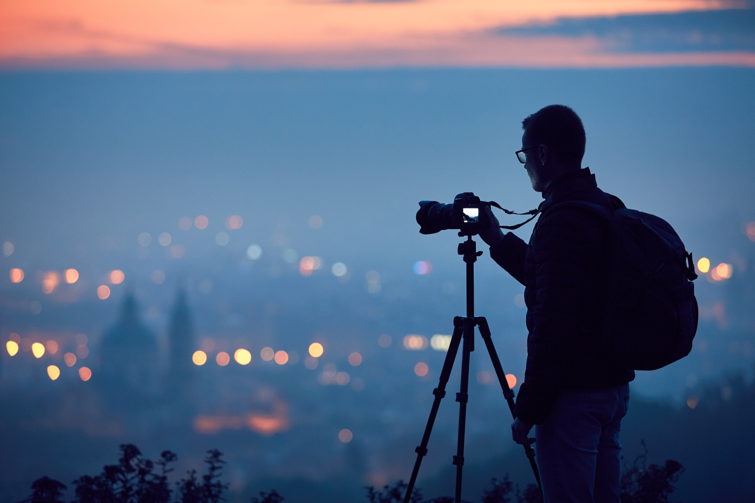 Silhouette of the photographer with tripod.
