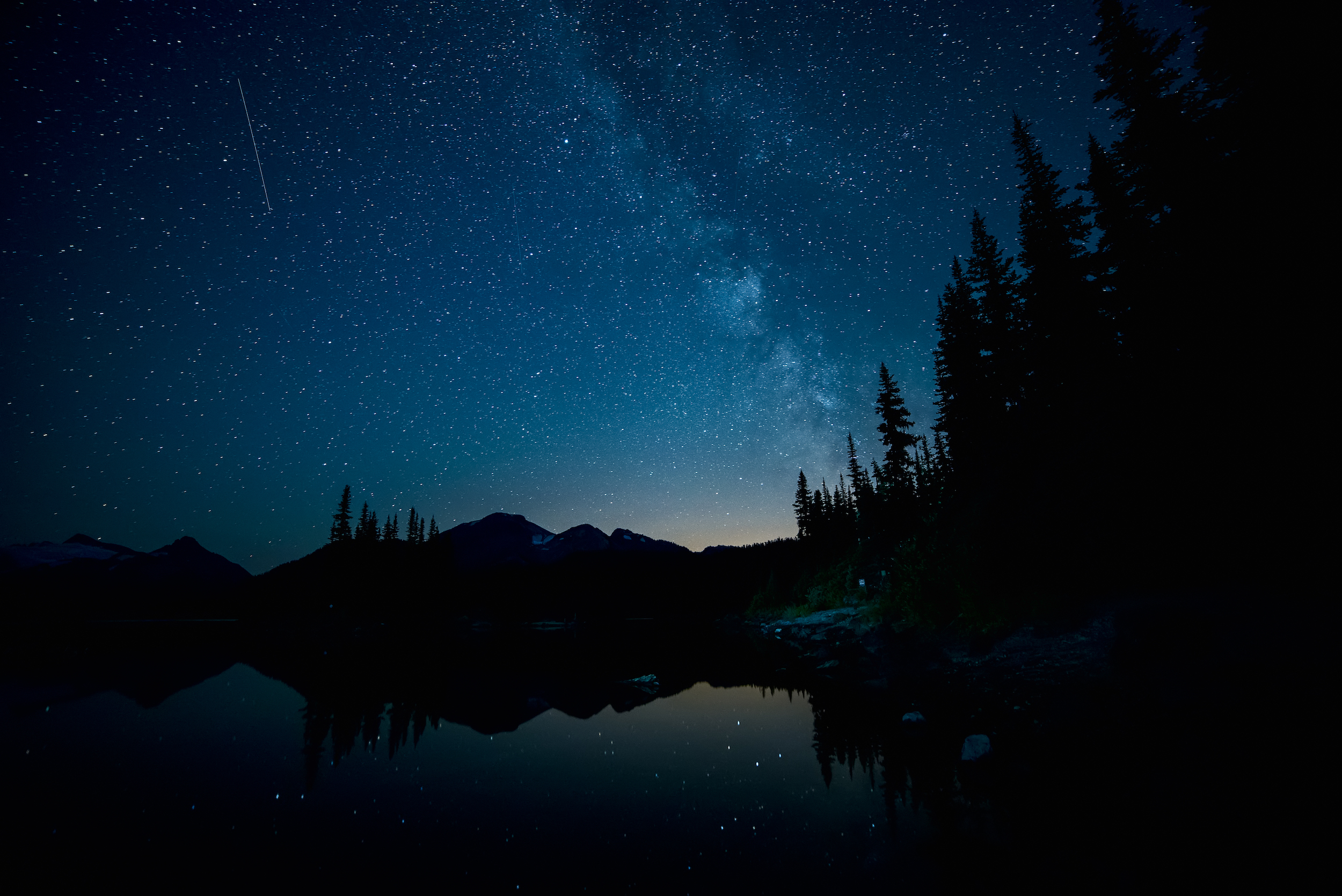 Forest and lake below the the Milky Way