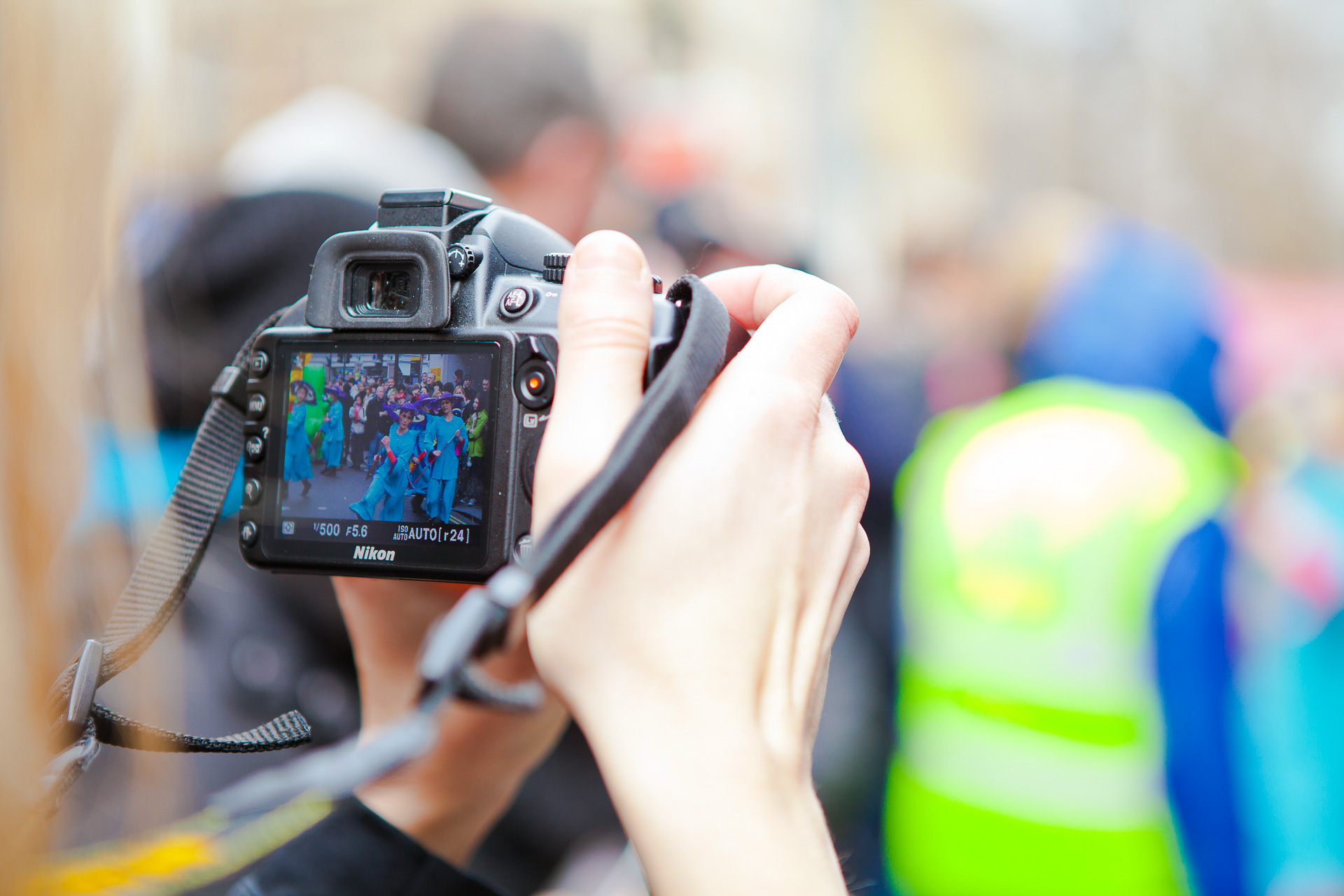 Photographer holding up a camera in a crowd