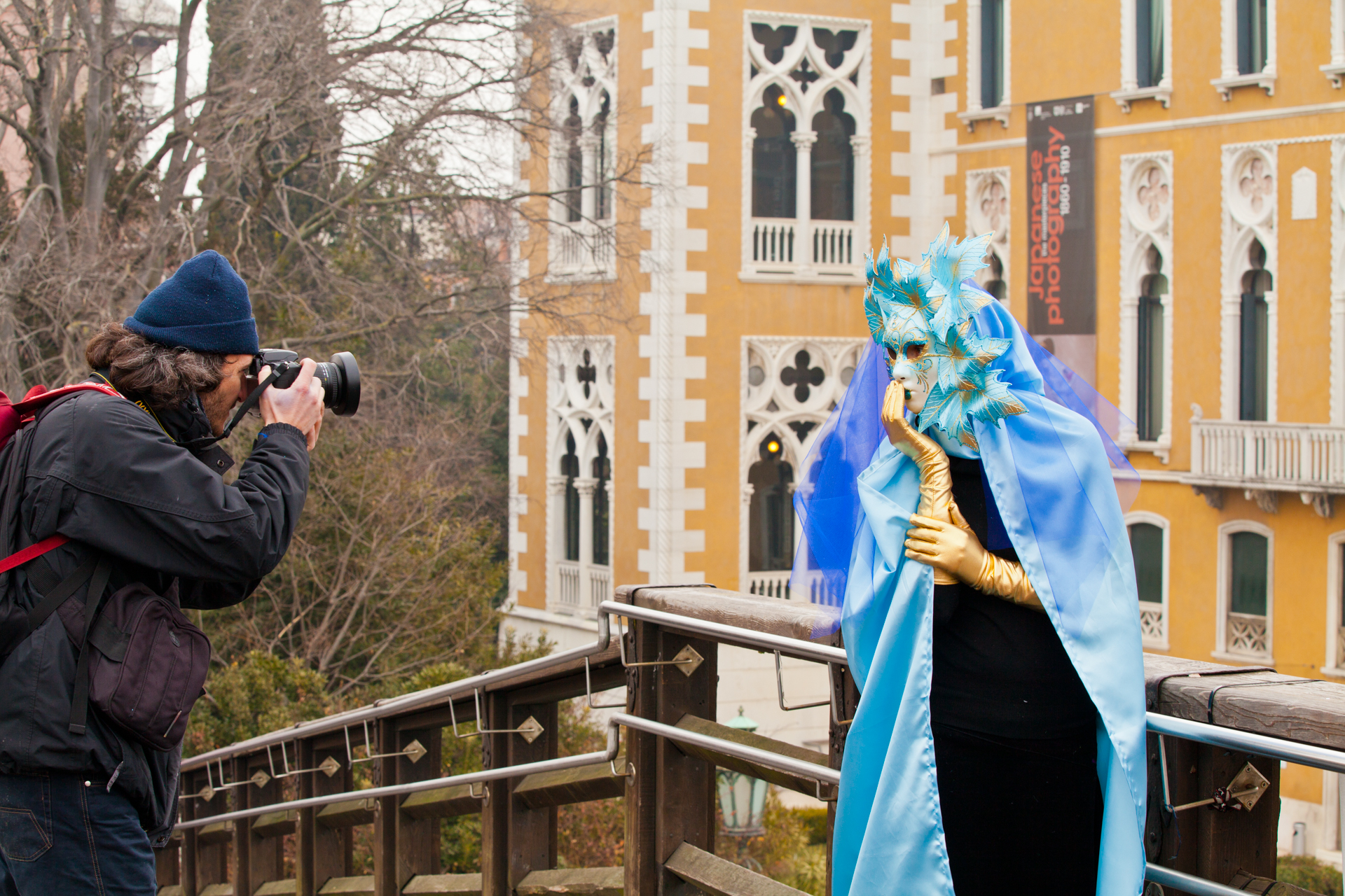 Photographer taking a picture of a reveler at Venice carnival